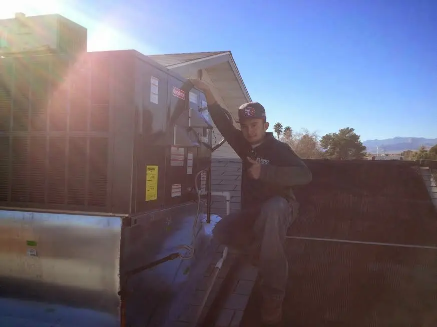 HVAC technician performing AC Tune-Up on a rooftop unit in Moncks Corner